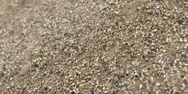 Lightweight insulating gravel stockpile used for underground utility bedding in Calgary–Edmonton, Alberta