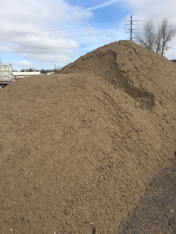 Washed, screened sand stockpile for leveling and playground bases in Calgary–Edmonton, Alberta